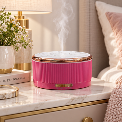 Rose pink Fragranzio diffuser in a bedroom setting